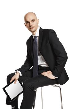 Portrait of young businessman sitting on chair. Studio shot isolated on white background.