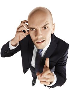 Above view of young businessman points his finger at you. Copy space. Isolated on white background.
