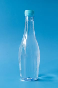 Plastic water bottle on blue background