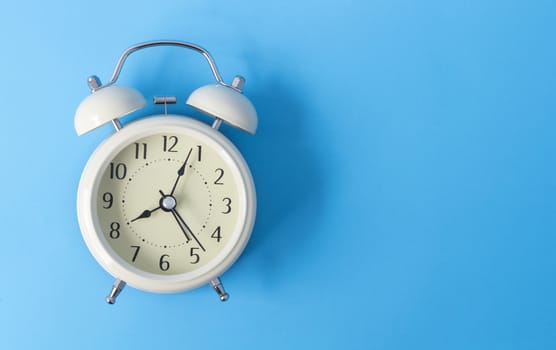 Retro alarm clock on grey background, time concept
