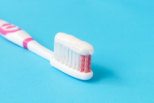 Closeup toothpaste with toothbrush on blue background