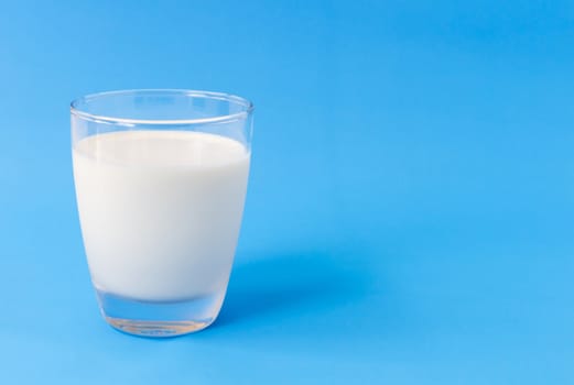 Glass of milk on blue background, food and drink for healthy concept