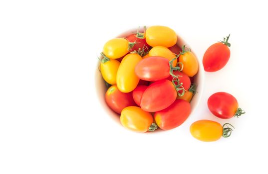 Top view fresh cherry tomatoes in bowl on white background