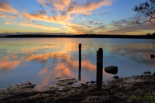 Sunset and mirror reflections in th tranquil waters.  Location St Georges Basin Shoalhaven Australia