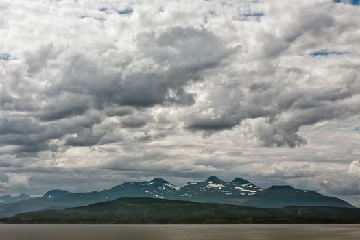 Mountains along the Romsdalsfjorden near Andalsnes under a cloudy sky, Norway