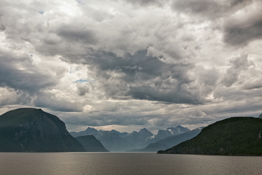 Mountains along the Romsdalsfjorden near Andalsnes under a cloudy sky, Norway