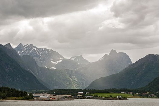 Andalsnes and mountains along the Romsdalsfjorden under a cloudy sky, Norway