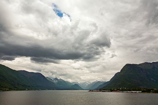 Mountains along the Romsdalsfjorden near Andalsnes under a cloudy sky, Norway