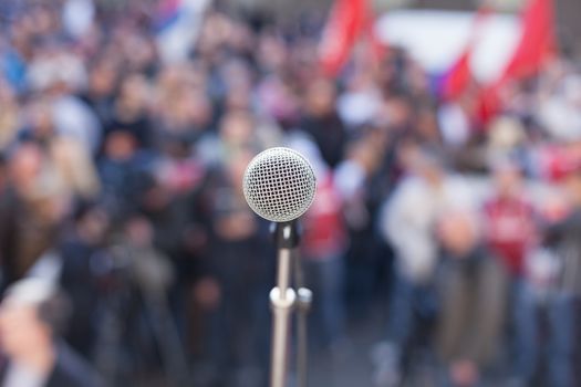 Microphone in focus against blurred crowd