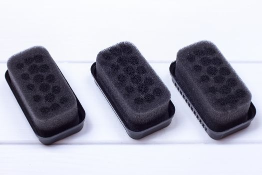 Black sponge for care of footwear on the white