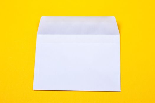 white open envelopes on the yellow background