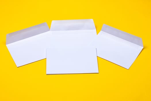 white open envelopes on the yellow background