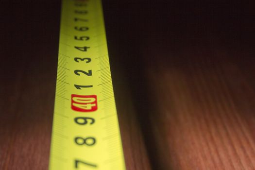Part of the measuring tape on a wooden table