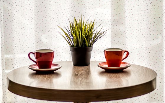 colorful tea cups on the wooden table