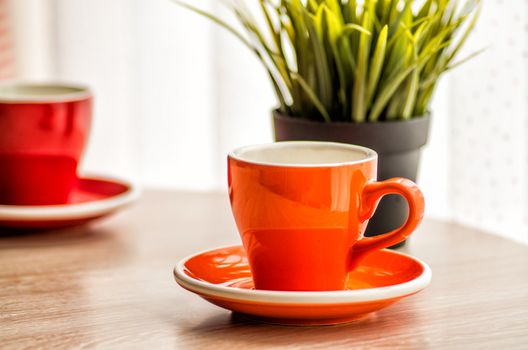 colorful tea cups on the wooden table