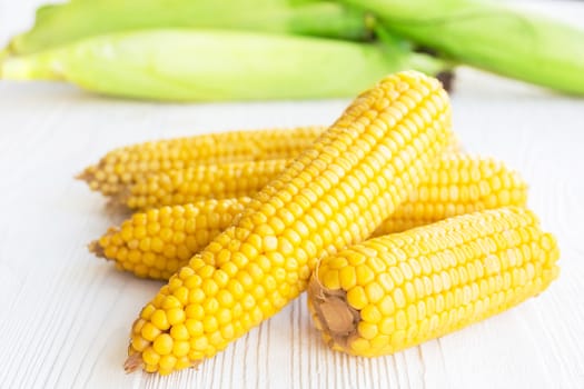 Boiled corn on white background, vitamins, diet