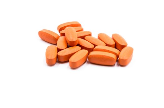 orange medicine pills on the white background