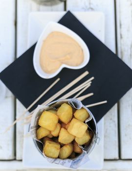 Traditional tapa from Spain. Cube bravas potatoes