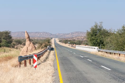 A large anthill next to a bridge on the C35-road between Ruacana and Kamanjab in the Kunene Region of Namibia