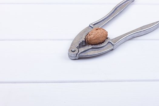 many walnuts on the white wooden background with copy-space