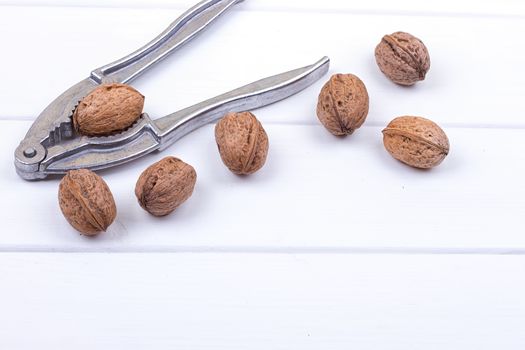 many walnuts on the white wooden background with copy-space