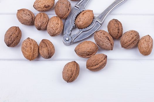 many walnuts on the white wooden background with copy-space