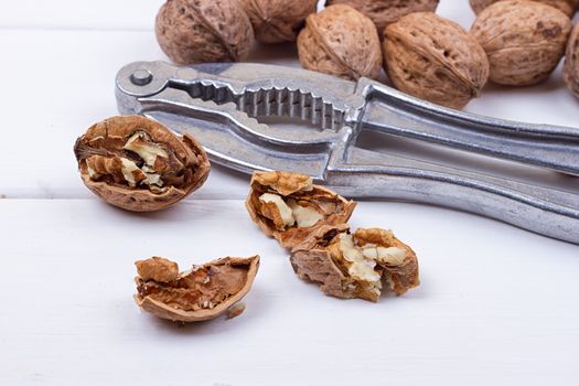 many walnuts on the white wooden background with copy-space