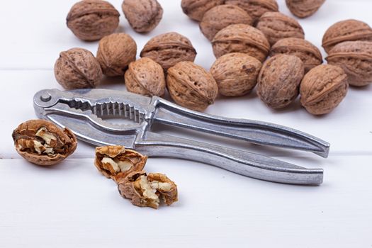 many walnuts on the white wooden background with copy-space