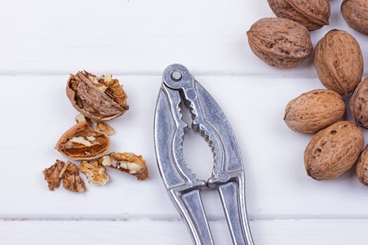 many walnuts on the white wooden background with copy-space