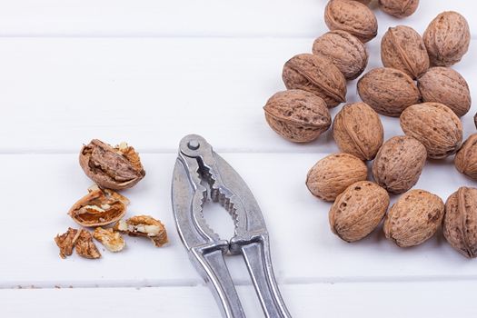 many walnuts on the white wooden background with copy-space