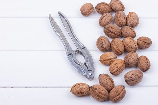 many walnuts on the white wooden background with copy-space