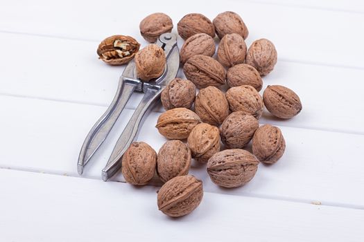 many walnuts on the white wooden background with copy-space