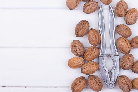 many walnuts on the white wooden background with copy-space