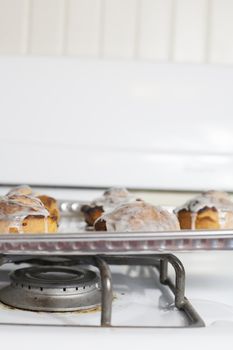 Fresh, iced cinnamon rolls on a baking sheet