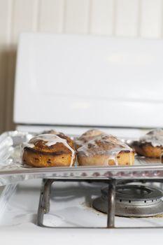 Fresh, iced cinnamon rolls on a baking sheet