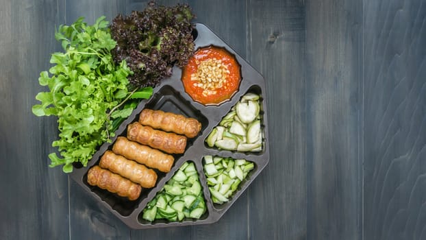 top view of roasted pork served with spicy sauce and vegetable (Nam Neung) on wooden background