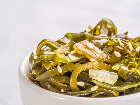 Extreme close up view of kelp seaweed salad with sesame seeds. Copy space.