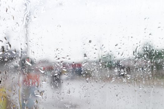 Rain drops on window glass with blur background