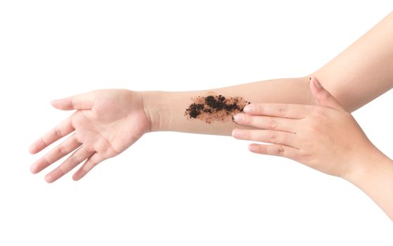 Woman's hand with scrub coffee grounds on skin hand and arm, beauty and healthy care concept