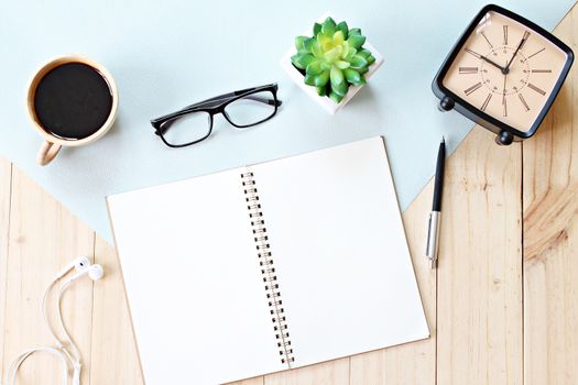 Still life, business, office supplies or education concept : Top view or flat lay of open notebook paper with blank pages, accessories and coffee cup on wooden background, ready for adding or mock up