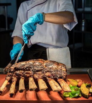 Chef Carving prime rib of  roast Wagyu beef 