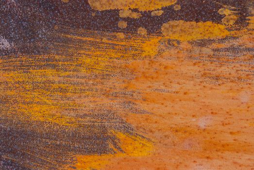 rusty iron surface covered with old chipped paint, which has long been influenced by different climatic conditions