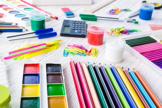 School supplies on a white background, paints and brushes