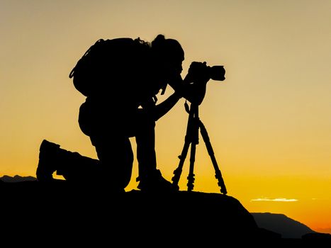 Photographer man silhouette in the nature