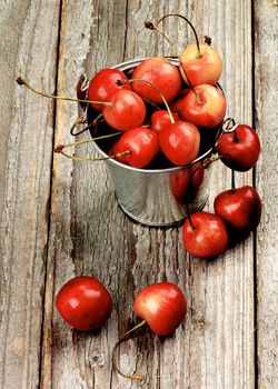 Arrangement of Ripe Sweet Maraschino Cherries in Tin Buckets closeup on Rustic Wooden background