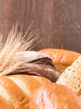 Close up view of differnet bread on brown wooden background. Copy space. Shallow DOF. Vertical.