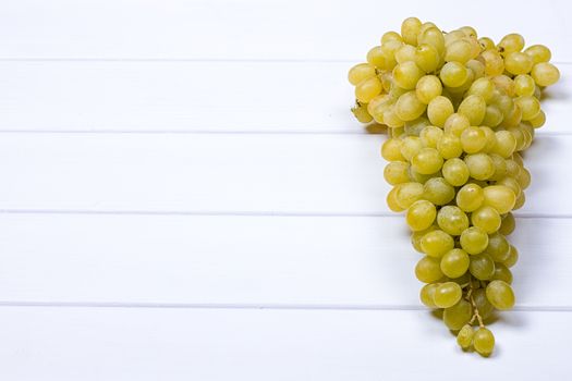 White grapes on white wooden surface. top view. copy-space