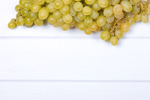 White grapes on white wooden surface. top view. copy-space