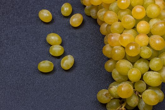 White grapes on a black background. copy-cpace