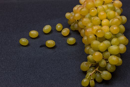 White grapes on a black background. copy-cpace